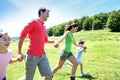 Portrait of joyful family running in the mountains Royalty Free Stock Photo