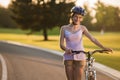 Portrait of joyful girl with bicycle outdoors. Royalty Free Stock Photo