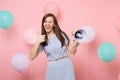 Portrait of joyful happy pretty young woman wearing blue dress blinking holding megaphone showing thumb up on pink Royalty Free Stock Photo