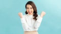 Portrait of a joyful happy teenage girl celebrating success while dancing isolated over blue background Royalty Free Stock Photo