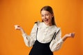 Portrait of a joyful happy teenage girl celebrating success on yellow background Royalty Free Stock Photo