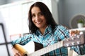 Smiling woman with guitar