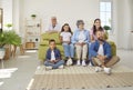 Portrait of joyful large family of three generations enjoying watching funny TV talk show together. Royalty Free Stock Photo