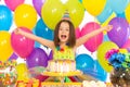 Portrait of joyful little girl with cake at