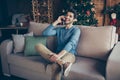 Portrait of joyful positive guy sit comfort couch communicate smartphone congratulate family 2020 newyear concept in Royalty Free Stock Photo