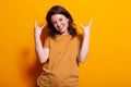 Portrait of joyful woman showing rock symbol with hands Royalty Free Stock Photo