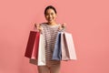 Joyful Young Asian Lady Posing With Lots Of Bright Paper Shopping Bags