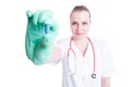 Portrait of joyful young female doctor holding a blue pill Royalty Free Stock Photo