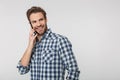 Portrait of joyful young man smiling and talking on cellphone Royalty Free Stock Photo