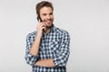 Portrait of joyful young man smiling and talking on cellphone Royalty Free Stock Photo