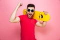 Portrait of a joyful young man in sunglasses celebrating Royalty Free Stock Photo