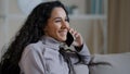 Portrait joyful young woman resting at home talking on telephone excited hispanic girl enjoy nice friendly chat share