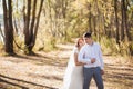 Portrait of just married wedding couple. happy bride, groom standing on beach, kissing, smiling, laughing, having fun in autumn pa Royalty Free Stock Photo