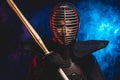 Portrait of kendo fighter in uniform and helmet Royalty Free Stock Photo