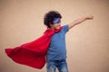 A portrait of kid boy in costume of superhero. Childhood and success concept Royalty Free Stock Photo