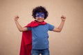 A portrait of kid boy in costume of superhero. Childhood and success concept