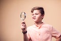 A portrait of kid boy holding magnifier. Children and knowlage concept Royalty Free Stock Photo