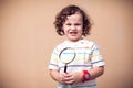 A portrait of kid boy holding magnifier. Children and knowlage concept Royalty Free Stock Photo