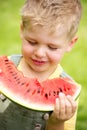 Portrait of a kid eating a slice of watermelon