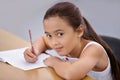 Portrait, kid and education of student taking notes in classroom for knowledge and development. Serious, girl and Royalty Free Stock Photo