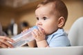 Portrait of kid keeping hands on the bottle Royalty Free Stock Photo