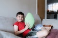 Portrait Kid looking at camera with smiling face and holding plush toy, Cute boy sitting on sofa relaxing after finished homework Royalty Free Stock Photo