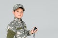 portrait of kid in military uniform with stop watch in hand looking at camera Royalty Free Stock Photo
