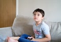 Portrait kid playing video game. Child holding console play game online with friends at home, Young boy siting sofa having fun and Royalty Free Stock Photo