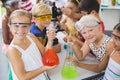 Portrait of kids holding laboratory flask in laboratory Royalty Free Stock Photo