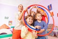 Portrait of kids with teacher looking though hoops Royalty Free Stock Photo