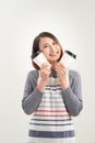 Portrait of kind friendly pleasant girl giving two big latte isolated on gray background copy-space