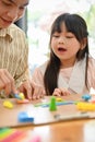 Portrait, Asian dad and girl playing at home, moulding colorful clay or plasticine together