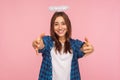 Portrait of kind positive girl with nimbus over head stretching arms to camera with friendly generous smile