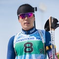 Portrait Korean sportsman biathlete Yang Seon Jik South Korea at finish after rifle shooting and skiing. Junior biathlon