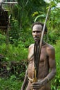 The Portrait Korowai hunter with arrow and bow.