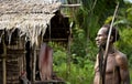 The Portrait Korowai hunter with arrow and bow.