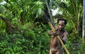 The Portrait Korowai hunter with arrow and bow.