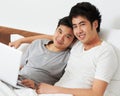 Portrait, laptop and bed with a gay couple watching a movie together while bonding in the morning. Love, happy or smile Royalty Free Stock Photo