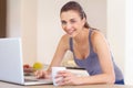 Portrait, laptop and coffee with a woman in the kitchen of her home to study or relax in the morning. Computer, smile Royalty Free Stock Photo