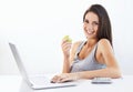 Portrait, laptop and woman nutritionist with apple in studio for wellness, diet or eating plan on white background