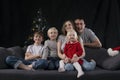 Portrait of large friendly family on Christmas Eve. Mom dad and three children at home on Christmas tree background Royalty Free Stock Photo