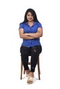 Portrait of a latein woman sitting on a chair on white background Royalty Free Stock Photo