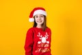 Portrait of Latin child girl holding Christmas gift box on a yellow background in Mexico latin america Royalty Free Stock Photo