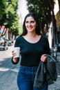 Portrait of a latin woman walking in the streets of a colonial city in latin america