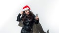 Portrait of latin woman wearing Santa`s hat for christmas with headphones listening music on white background Royalty Free Stock Photo