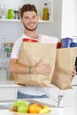 Portrait latin young man holding grocery shopping bags Royalty Free Stock Photo