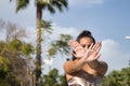 Portrait of Latina and Hispanic girl, young and beautiful, doing modern dance hand movements in the street outdoors. Dance concept