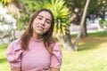 Portrait of a Latina teenage girl with braces looking at camera outdoors dressed in a pink blouse in a park Royalty Free Stock Photo