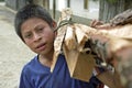 Portrait of Latino boy with firewood on shoulder