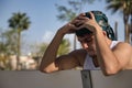 Portrait of Latino and Hispanic boy, young, rebellious, with headscarf and hands on head, sad, lonely, pensive and stressed, Royalty Free Stock Photo